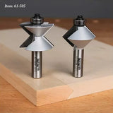 Two carbide router bits with bearings for woodworking, displayed on a wooden board.