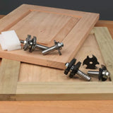 Cabinet door rail and stile router bit set on wooden panels, woodworking tools display