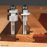 Dovetail router bits with ball bearing guides shown beside interlocking wooden joints on a workbench.