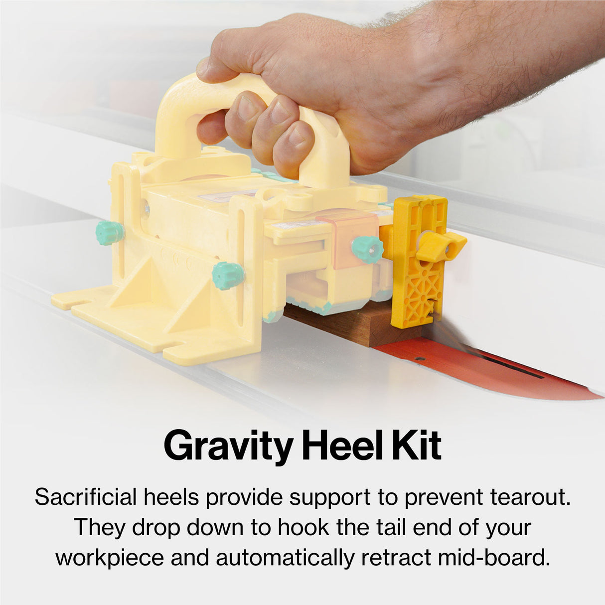Gravity heel kit for table saw, yellow push block on wood, hand holding tool for safety and support.