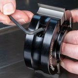Hand using Allen wrench to adjust woodworking insert pro system shaper cutter head