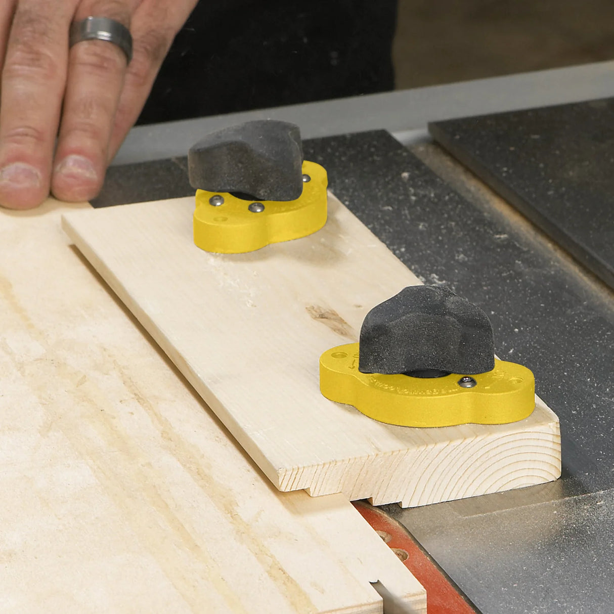 Push blocks clamping wood on table saw for safe woodworking and precise cuts