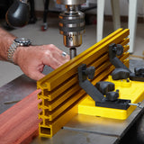 Drill press fence system with gold anodized track and clamps, woodworking setup in use