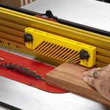 Table saw featherboard guiding wood for precise woodworking and safety