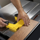 Using a yellow push block with table saw for safe woodworking and precise wood cutting.