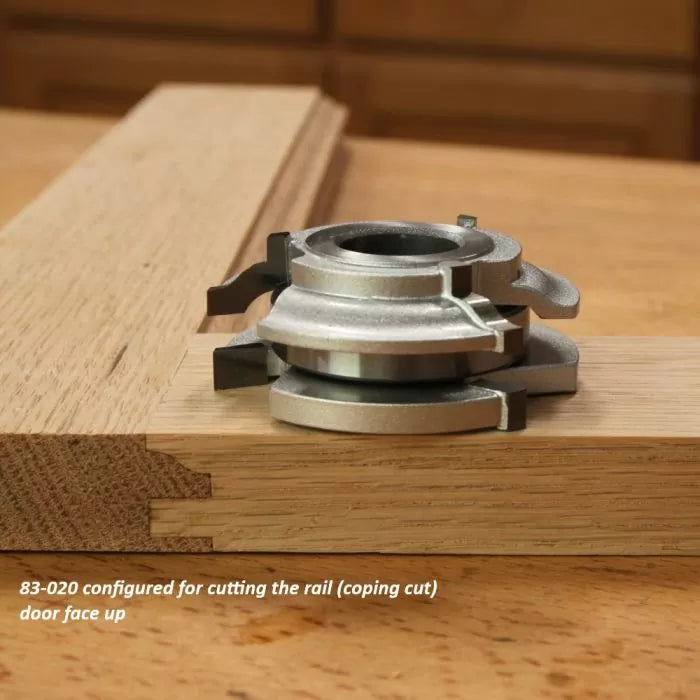 Woodworking rail coping cutter head on oak panel for precision door joinery