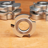 Carbide-tipped woodworking shaper cutter head on a wooden surface