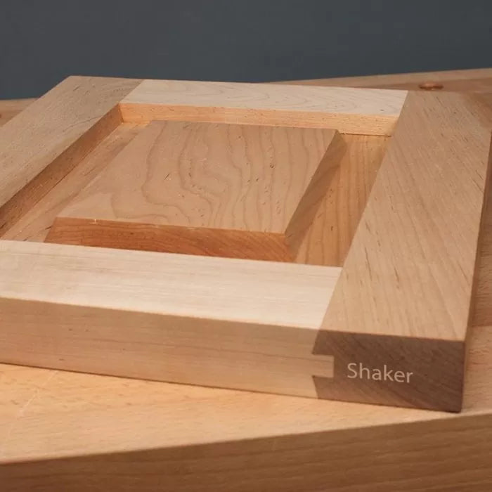 Shaker style cabinet door sample with dovetail joinery on a wood workshop table