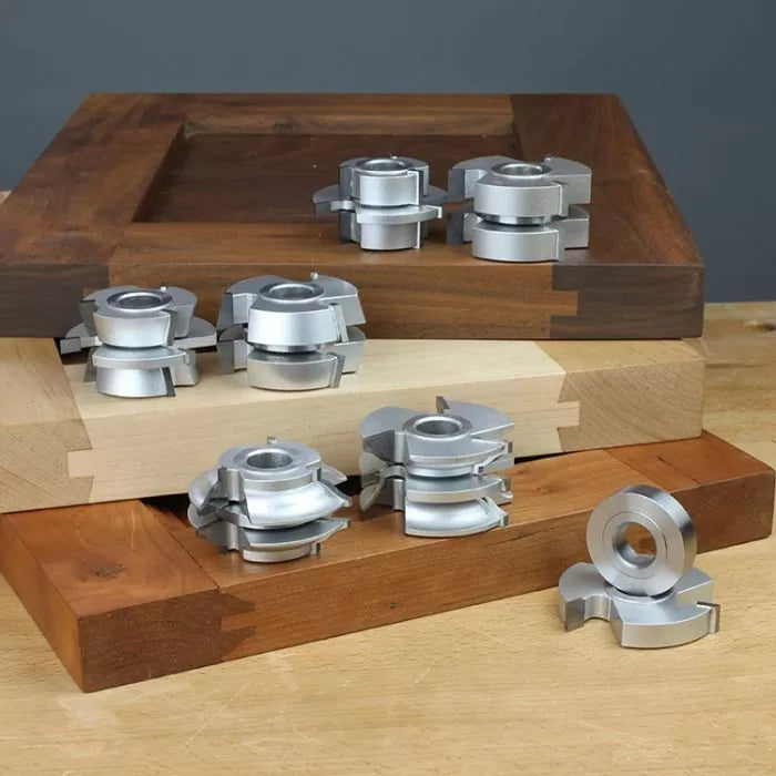 Stacked woodworking shaper cutters on dovetailed wood boards for joinery and cabinet making