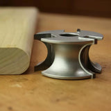 Display cutter woodworking tool with finished wood edge profile on workbench