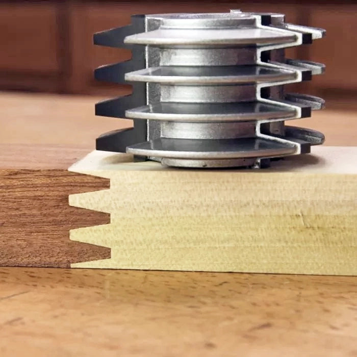 Wood joinery cutter head with interlocking finger joint profile on two wood boards