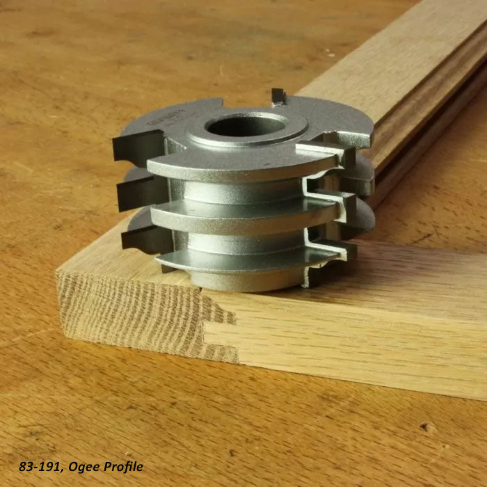 Ogee profile router cutter head with joinery sample on a woodworking bench