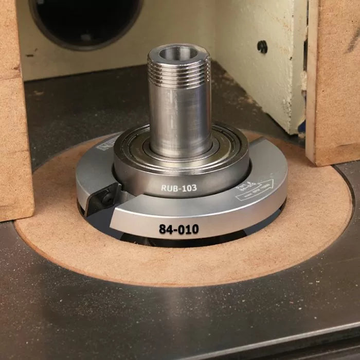 Router table spindle with 84-010 insert cutter and RUB-103 guide for woodworking precision.