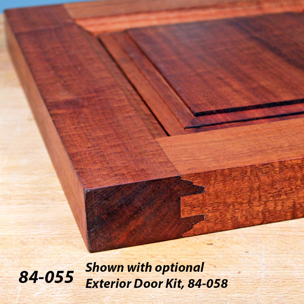 Close-up of a hardwood cabinet door corner with joinery detail on a wooden workbench