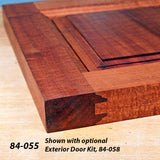 Close-up of a hardwood cabinet door corner with joinery detail on a wooden workbench