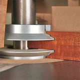 Woodworking router bit cutting precise joinery profile on hardwood edge