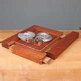 Woodworking shaper cutter set with steel router bits and tenon joints on a wooden workbench
