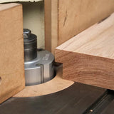 Wood shaper cutter head machining hardwood edge on router table, woodworking tool closeup