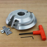 Carbide woodworking shaper cutter head with replaceable blades, Allen keys, on wood surface