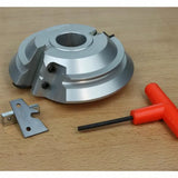 Aluminum woodworking cutter head set with blade and hex key on a wooden surface.