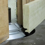 Woodworking shaper cutter creating decorative edge on wood panel