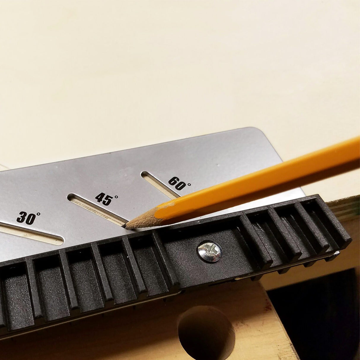 Milescraft FrameSquare protractor showing 30, 45 and 60 degree angle markings with a pencil