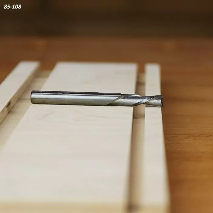 Straight carbide router bit on a wooden board, woodworking tool for precise cutting