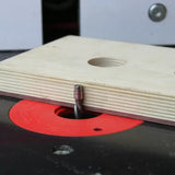 Router bit with bearing set up on a router table with plywood for woodworking precision