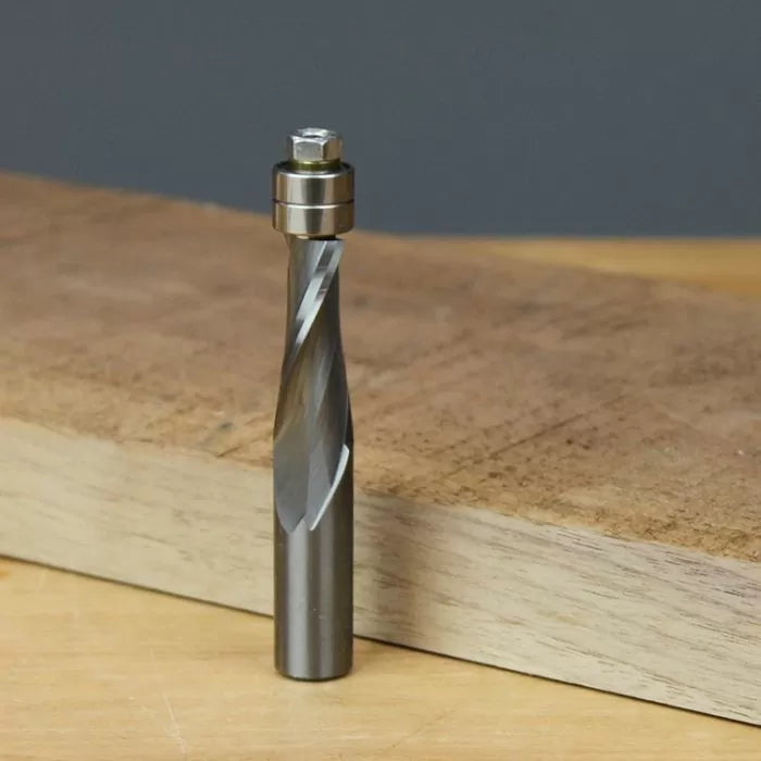 Straight flute router bit with bearing guide on wooden workbench, woodworking tool
