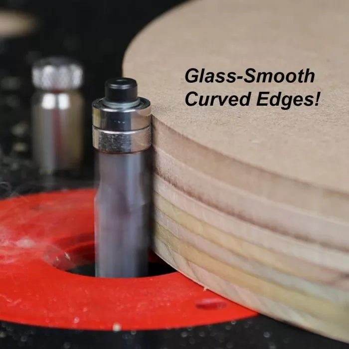 Carbide flush trim router bit creating smooth curved edges on plywood in a router table.