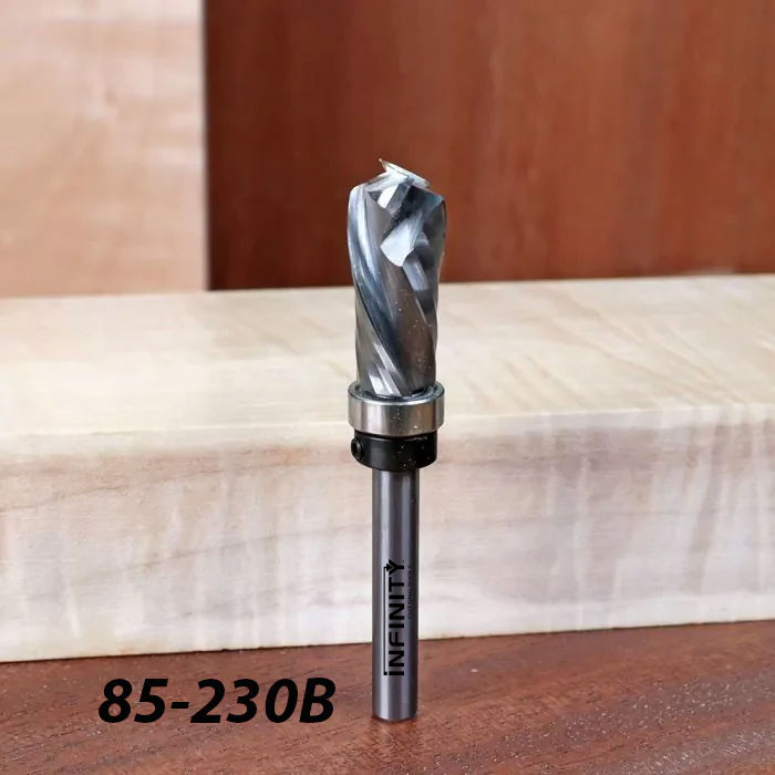 Spiral router bit with bearing for woodworking, model 85-230B, standing on wood surface