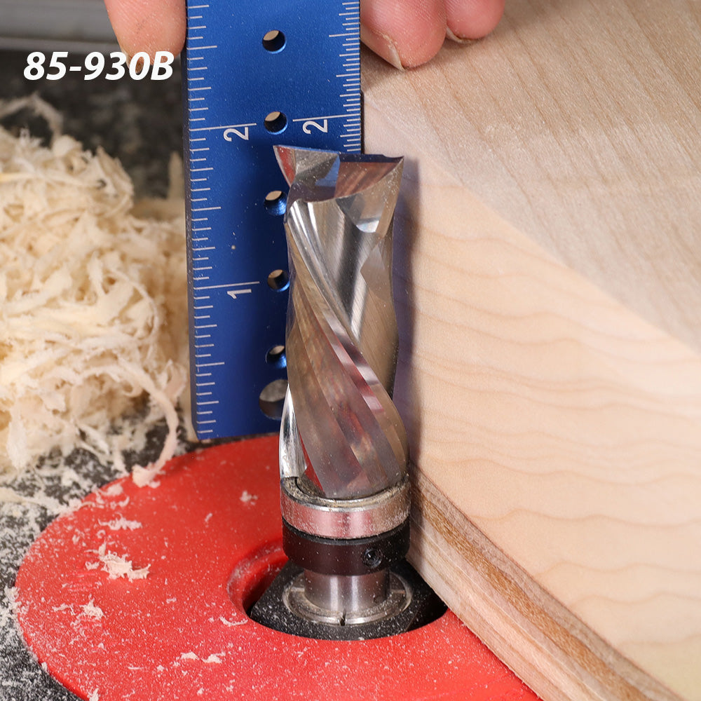 Carbide spiral router bit trimming wood edge, blue ruler for measurement, wood shavings visible