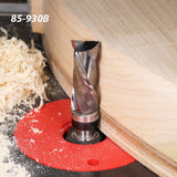 Straight router bit trimming wood edge on router table with wood shavings and part number 85-930B visible.