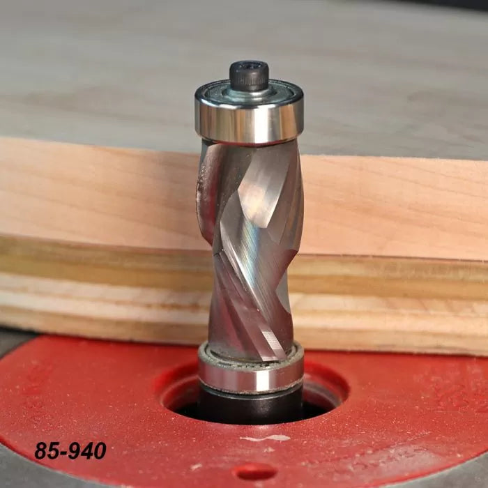 Spiral flush trim router bit with bearing cutting plywood on a router table