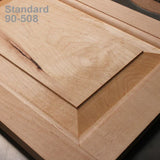 Close-up of a wooden cabinet door panel with beveled edges and natural wood grain texture.