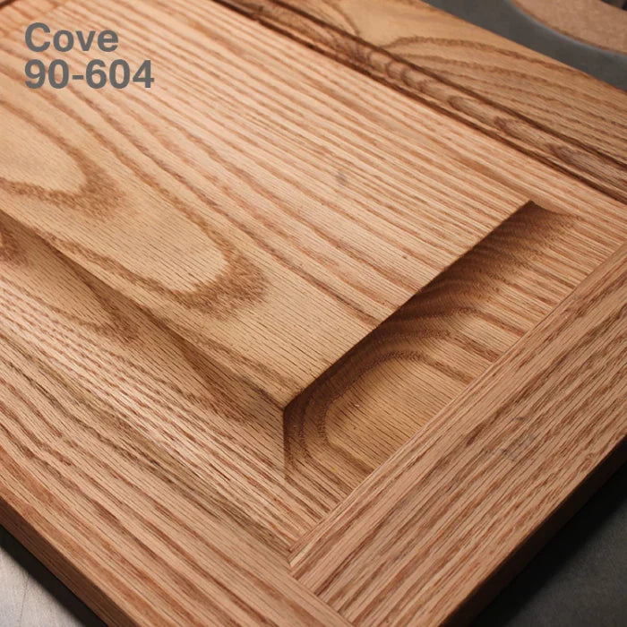 Close-up of a wooden cabinet door panel with a cove profile groove, showcasing the 90-604 cove detail.