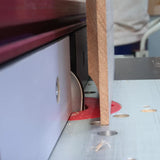 Router table with saw blade cutting MDF wood, woodworking tool in use