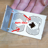 Anti-skid metal woodworking jig with etched grip patterns and cutouts, held by hand