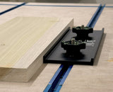 Bow clamp securing wood board on woodworking table with T-track system