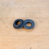 Steel router guide bushings on wooden workbench, woodworking tool accessories