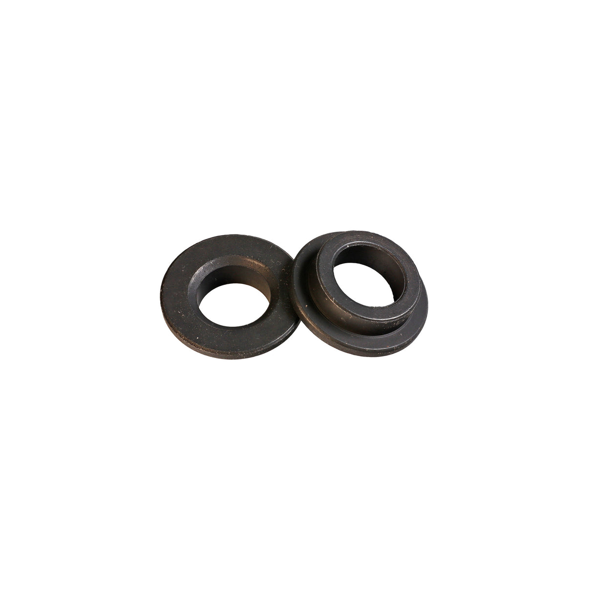 Pair of black saw blade bushings for woodworking tools on white background