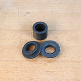 Router guide bushings set on wooden surface for woodworking and routing projects