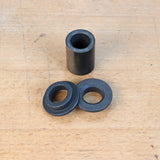 Steel router bushing set on woodworking bench, ideal for precise routing and jig setup