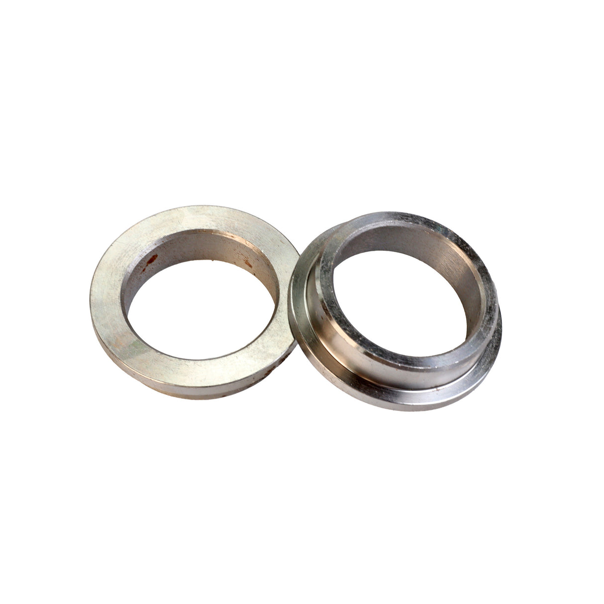 Two metal saw blade bushings for woodworking tools on a white background