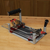 Woodworking joinery jig with adjustable clamps on a workbench for precise cuts