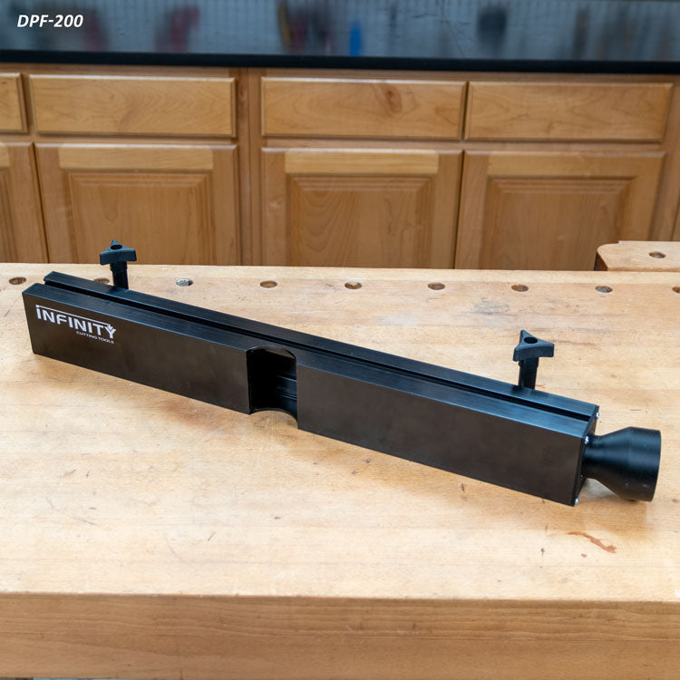Router table dust collection fence with black aluminum body on a wooden workbench