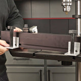 Drill press fence system mounted on a drill press table in a woodworking shop