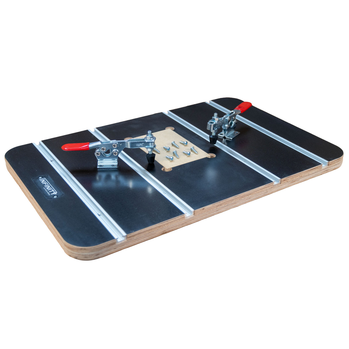 Woodworking jig with T-tracks, toggle clamps, and hardware on a black tabletop