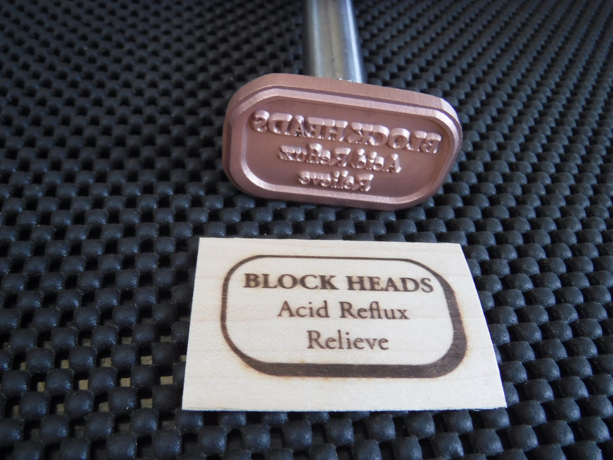 Custom wood branding iron for woodworking with engraved wood sample on textured mat