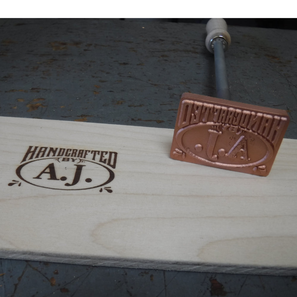 Custom branding iron for woodworking with 'Handcrafted by A.J.' stamp on wood surface.